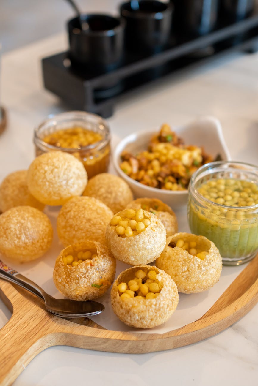 indian food pani puri on a wooden tray